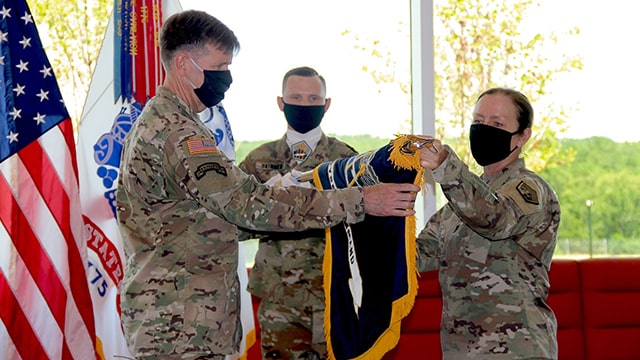 LTG Forgarty unrolling the ARCYBER flag with another soldier